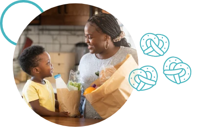 Family smiling looking at bags with food - Newmarket Food Pantry